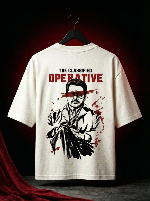 Off-white oversized graphic t-shirt hanging on hanger showing full back print with bold illustrated character and red accents, cinematic spy inspired design, streetwear oversized tee India, premium cotton graphic t shirt men
