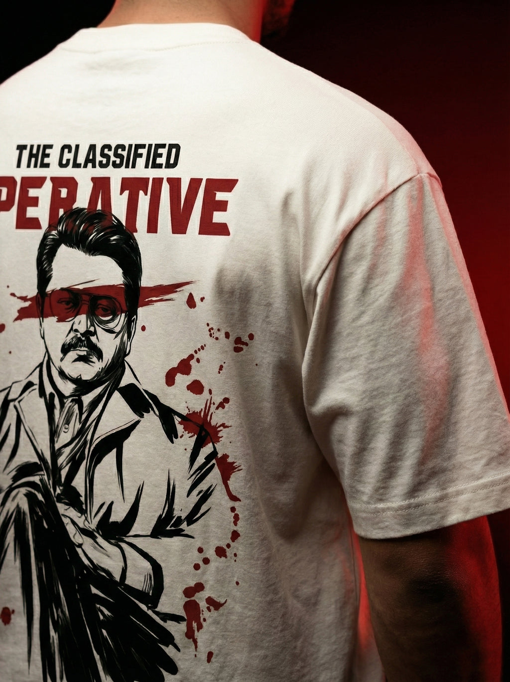 Close-up of oversized graphic t-shirt back print showing detailed illustrated undercover spy character with red cinematic accents, high-quality DTG print texture, gangster aesthetic clothing India, bold statement streetwear t shirt