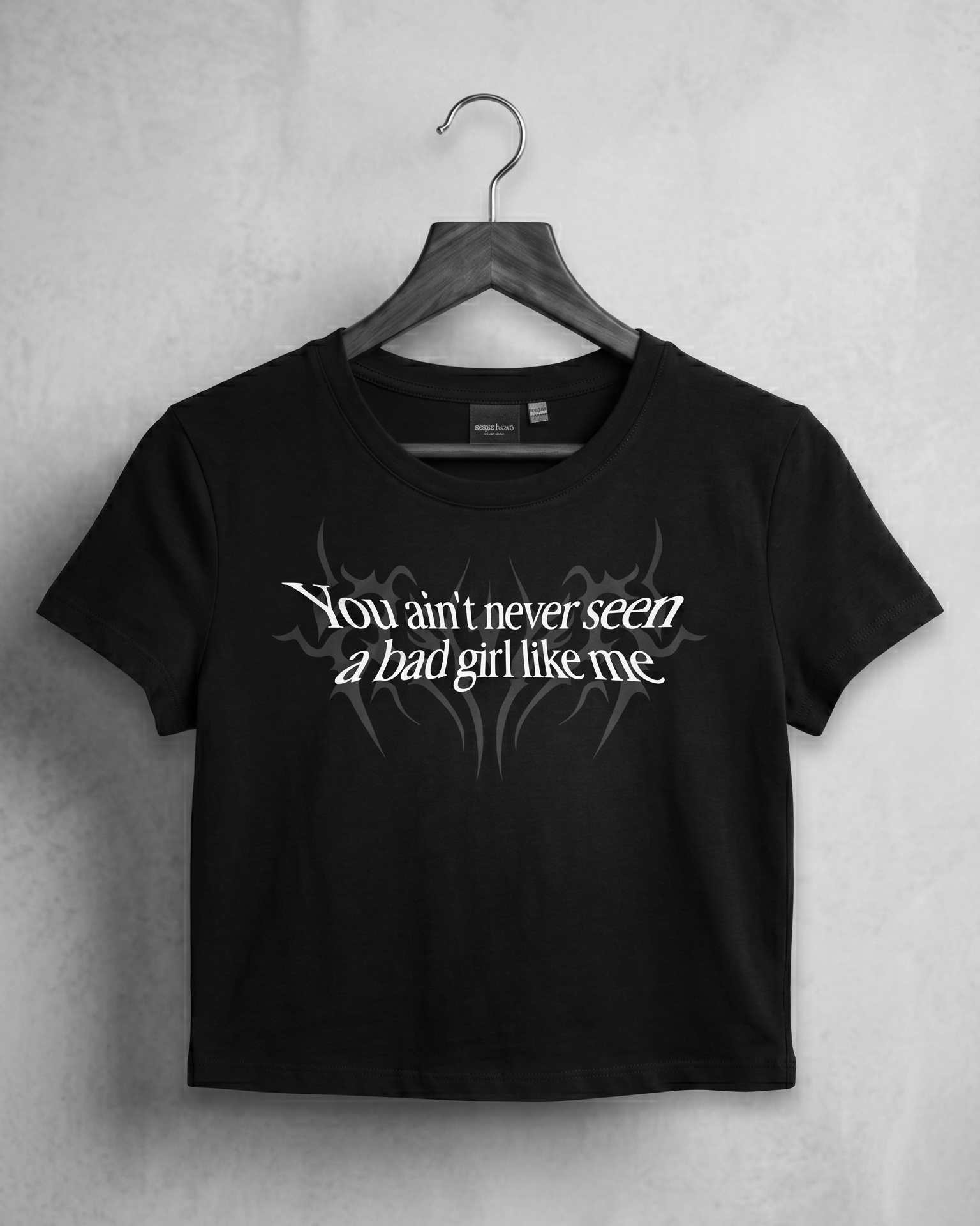 Black aesthetic crop top for women with bold bad girl quote graphic, gen z streetwear fashion inspired by underground rap reble style and dhurandhar cinematic attitude