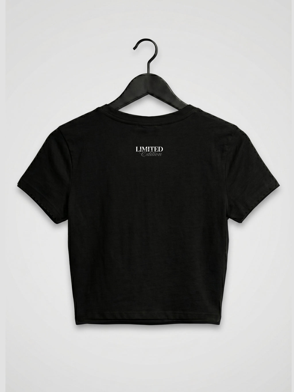 Back view of black women’s crop top with minimal limited edition print, premium gen z streetwear inspired by dhurandhar aesthetic and underground rap reble vibe
