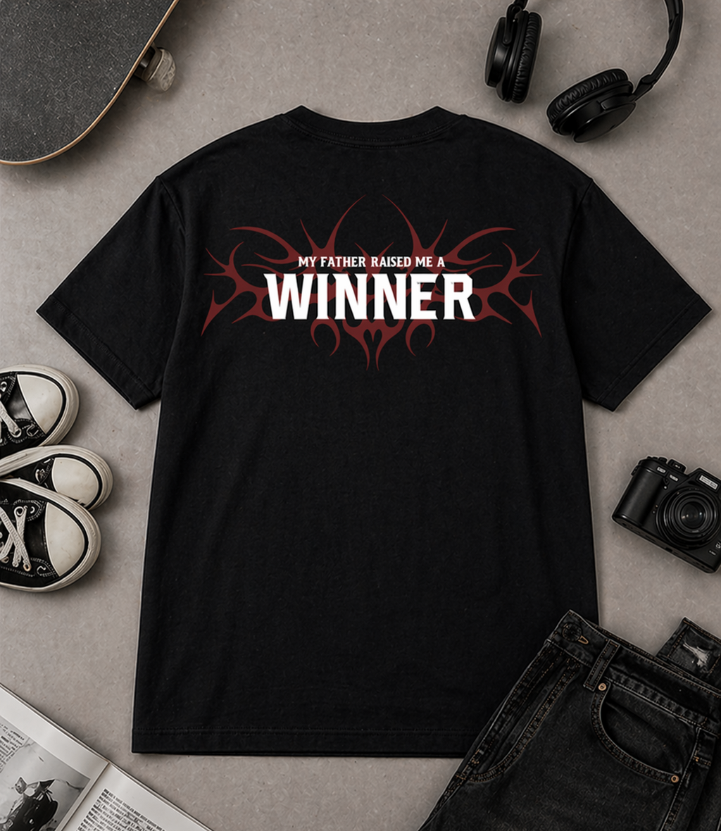 "Flat lay of Noverra Dhurandhar My Father Raised Me A Winner black oversized boxy t-shirt with back print, styled with sneakers headphones camera, best Gen Z graphic tee India 2026"