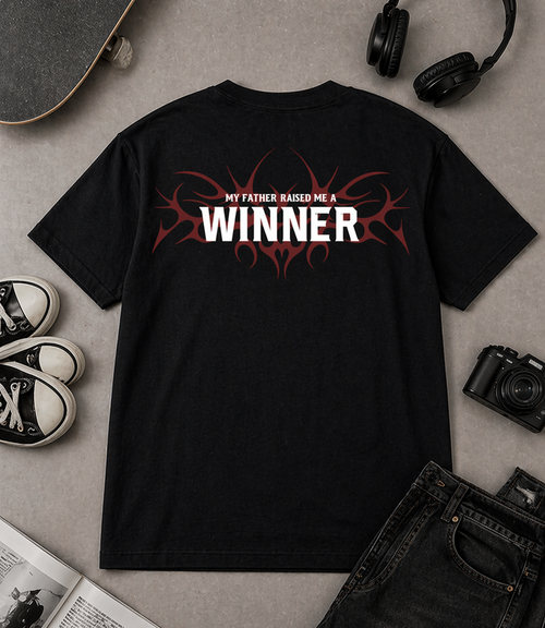 "Flat lay of Noverra Dhurandhar My Father Raised Me A Winner black oversized boxy t-shirt with back print, styled with sneakers headphones camera, best Gen Z graphic tee India 2026"