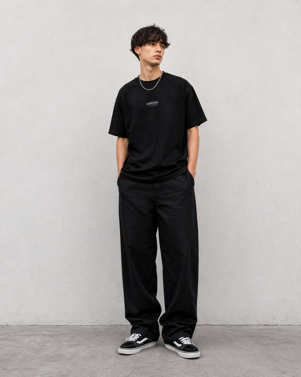 "Gen Z male model wearing Noverra Dhurandhar limited edition black boxy fit oversized t-shirt with small Limited Edition chest print, 240 GSM heavy cotton streetwear India"