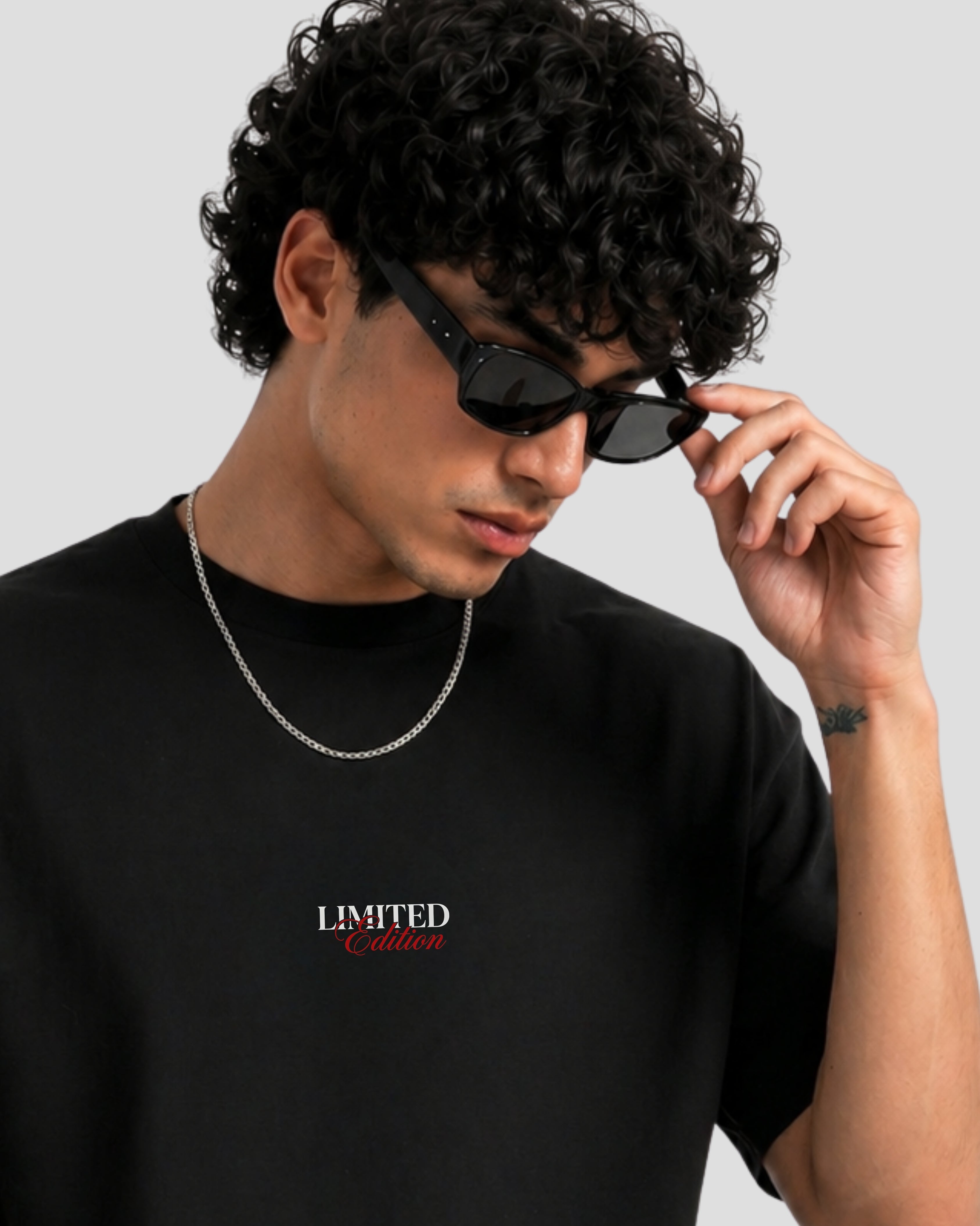 Man wearing Noverra SINNER limited edition black boxy fit oversized t-shirt, drop shoulder 240 GSM heavy cotton streetwear for men India 2026