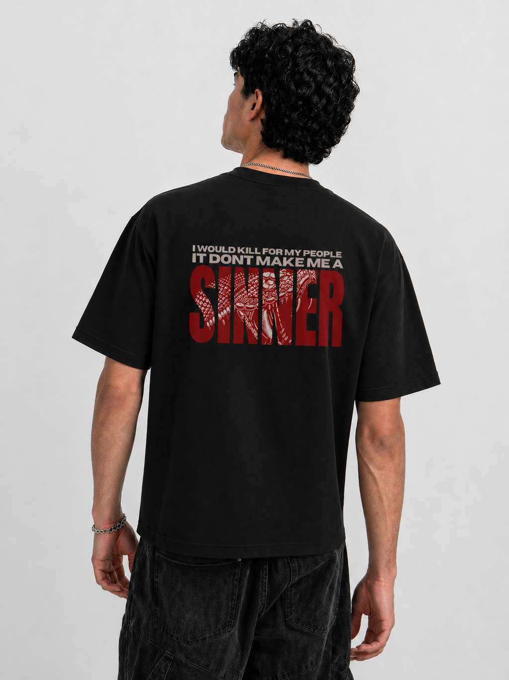 Back view of man wearing Noverra Dhurandhar SINNER 240 GSM oversized boxy fit t-shirt with I would kill for my people back print, best Gen Z streetwear India