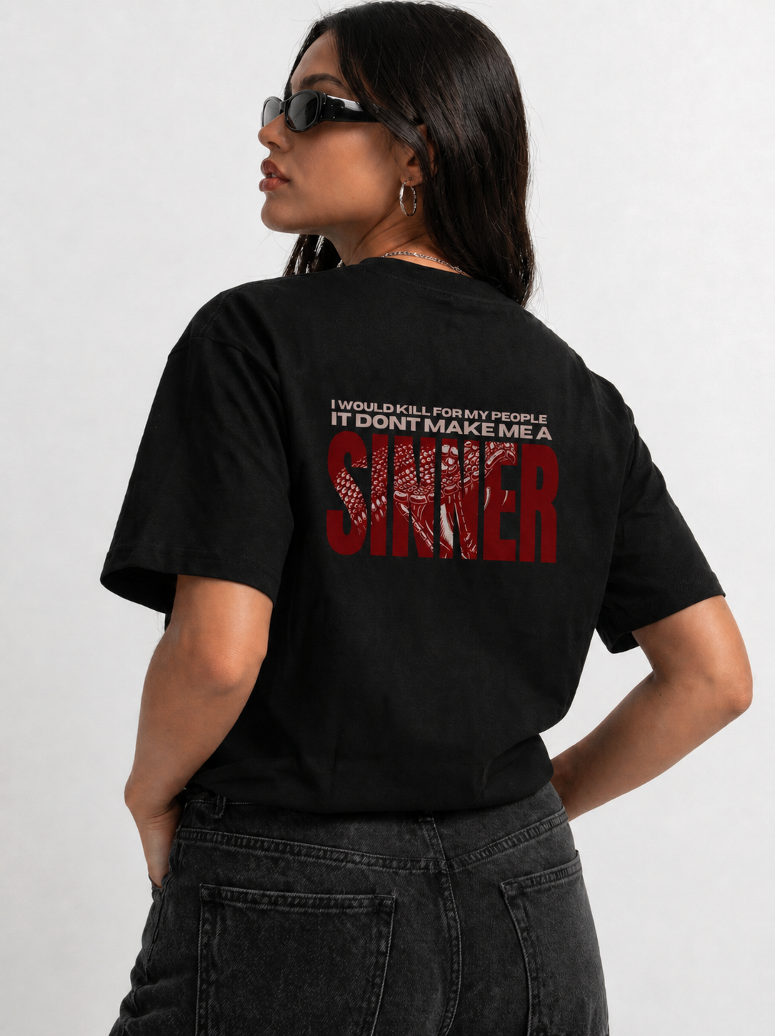 Back view of woman in Noverra SINNER oversized boxy t-shirt showing large red SINNER back print, women's heavy cotton graphic tee India